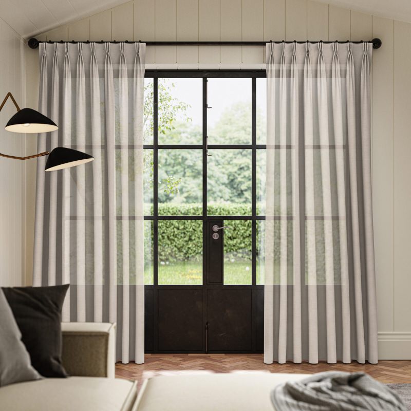 Dalkey Quartz Sheer Curtain, a warm-toned lightweight fabric creating a soft glow.