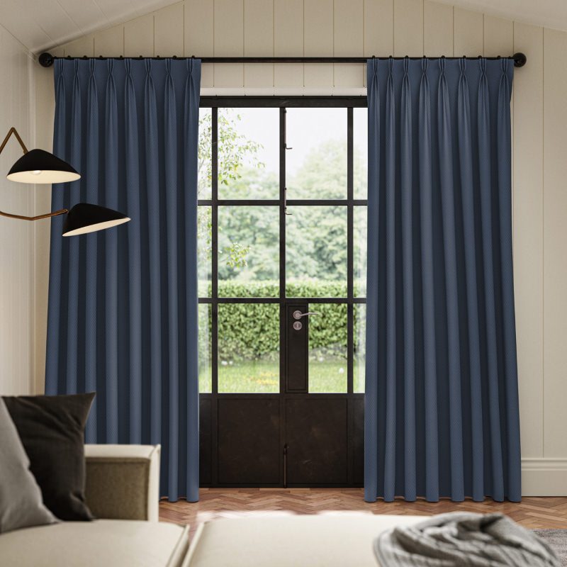 Meryl Indigo Pocketed Curtain in a deep indigo hue, hanging in soft, gathered folds.